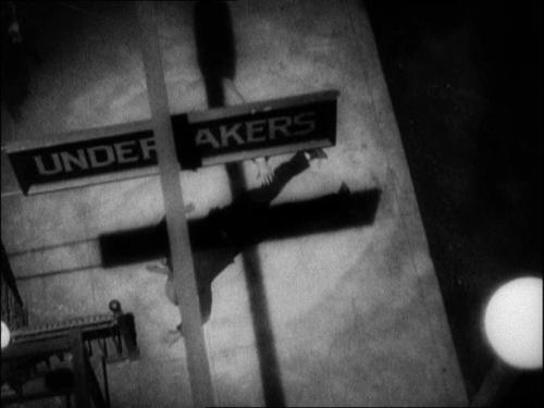 Whether by neon sign or shadows, the film features an "X" motif throughout. This is one caused by shadows of an "Undertakers" sign