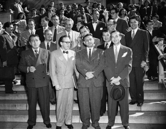 October 27, 1947, Washington, DC: The group of Hollywood writers and producers summoned to appear before HUAC photographed leaving the investigation. Front row: Lewis Milestone, Dalton Trumbo, John H. Lawson, who was cited for contempt, and Bartley Crum, attorney for witnesses. Center row: Gordon Kahn, Irving Pichel, Edward Dmytryk, Robert Rossen. Top row: Waldo Salt, Richard Collins, Howard Koch and Albert Maltz; Herbert Biberman; Lester Cole and Ring Lardner, Jr., writers and Martin Popper, another attorney for the group. Photo G.B. Kress, Corbis.