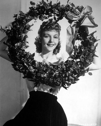 Relative Hollywood newcomer, Mary Martin in a studio-inspired pose wishing everyone the merriest of days