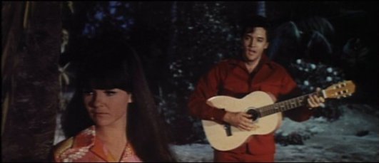 It may look like Elvis is singing to Shelley Fabares while strumming a simple guitar, but one chord and an entire band can be heard