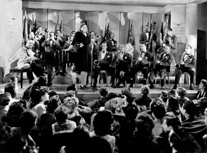 The Count Basie Orchestra accompanies Ethel Waters in the 1943 wartime film Stage Door Canteen.