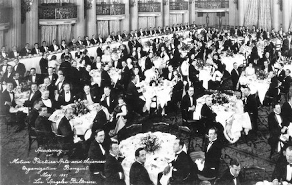11th May 1927: Interior view of formally dressed men and women seated at tables during the first organizational meeting of the Academy of Motion Picture Arts and Sciences in the Crystal Ballroom of the Los Angeles Biltmore Hotel. Mary Pickford, Douglas Fairbanks, Louis B. Mayer, Jack L. Warner and Darryl F. Zanuck attended the banquet. (Photo by Hulton Archive/Getty Images)