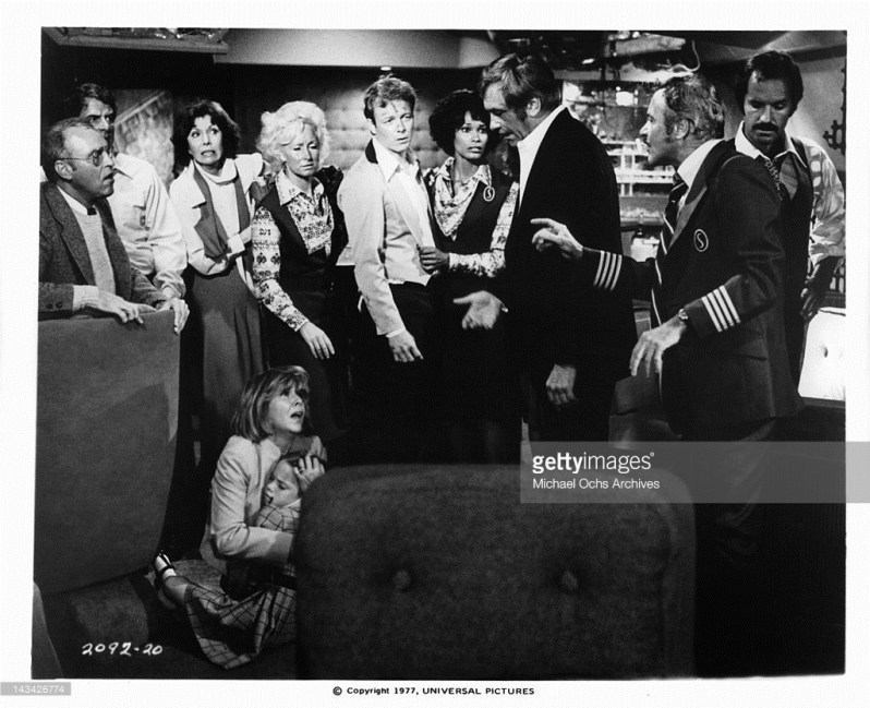 Jack Lemmon as captain, passengers and crew take stock after their 747 has been sent catapulting into the waters of the Bermuda Triangle in a scene from AIRPORT 77.